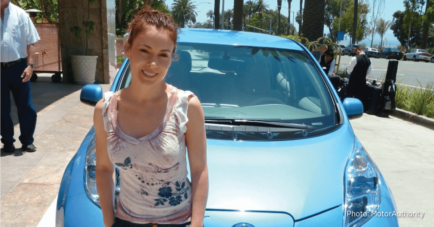 Alyssa Milano stands in front of one of her many EVs